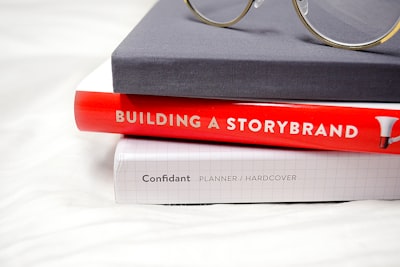 gold framed eyeglasses on black hardbound book