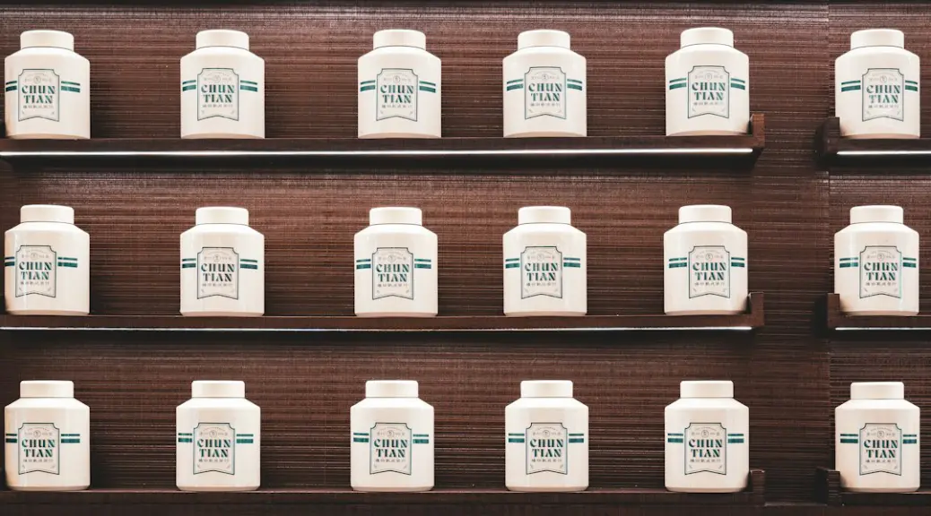 White crown tea bottles displayed neatly on wooden shelves
